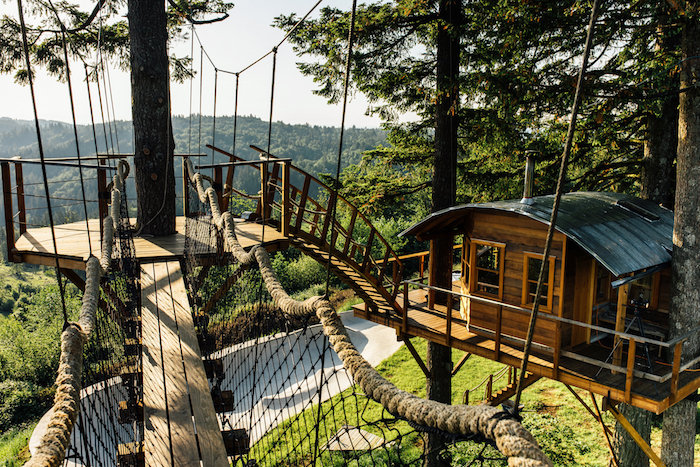 rope and wooden bridges, connecting several constructions, suspended above the ground, wooden tree house 