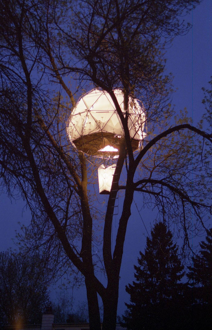 illuminated ballon-shaped structure, built on a tree, high above the ground, cool tree houses or tents, dark evening sky