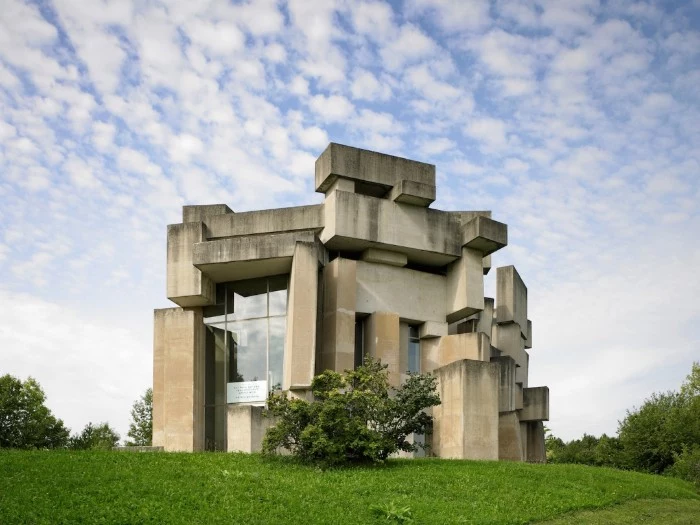 brutalism examples, the wotruba church, in vienna austria, asymmetrical concrete building, made up of many rectangular segments