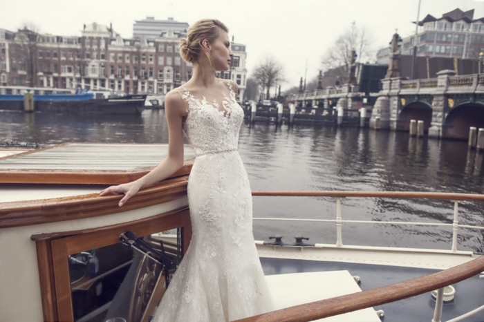 vintage wedding dresses, blonde bride on a boat sailing on the river Seine, wearing long white figure-hugging wedding dress with applique details and lace 