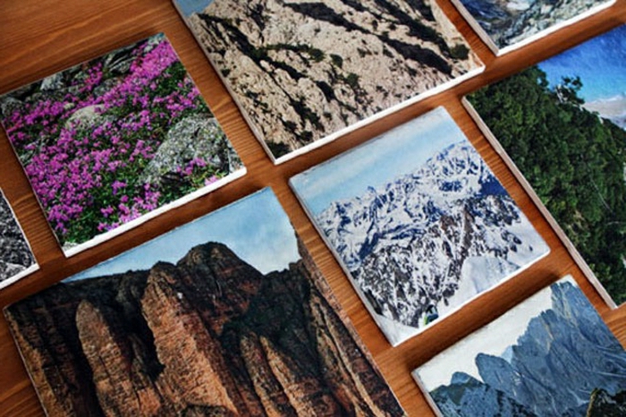 coasters made with beautiful nature photos, on a wooden table