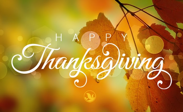 images of thanksgiving, happy thanksgiving in white writing, on a blurry green, orange and yellow background with a branch with orange leaves
