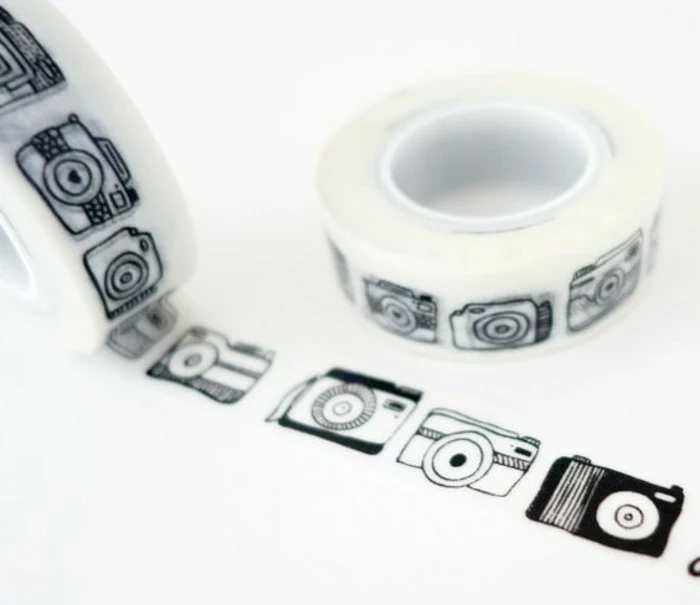 scrapbook ideas for beginners, decorative sticky tape with black camera design, two rolls, on white background