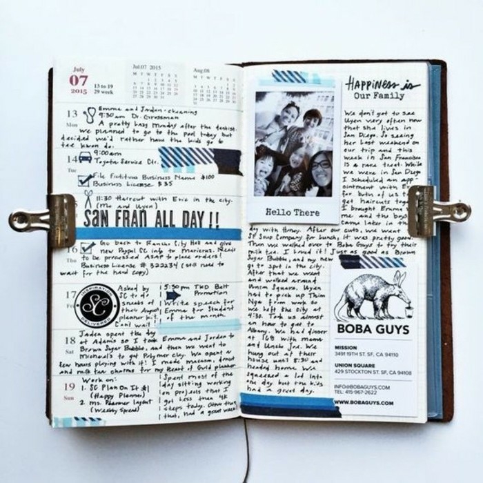 scrapbook page ideas, white background, open journal with blue details, a photo, a business card, lots of writing, dates, calendar