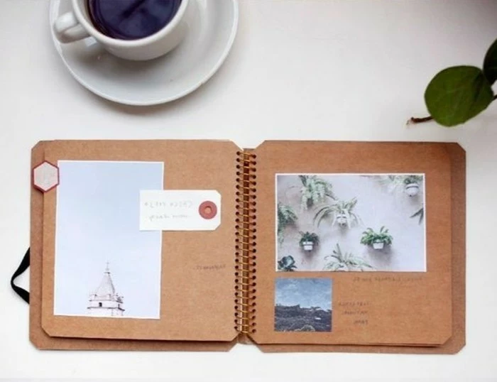  scrapbooking made simple, notebook made of brown recycled paper with three photos, on a white table with full coffee cup and green leaf