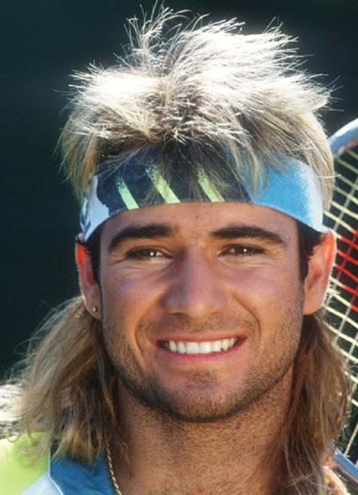 80's fashion for men, smiling andre agassi with blonde mullet, and blue navy and neon green tennis headband, stud earring and stubble, tennis racket partly visible in background