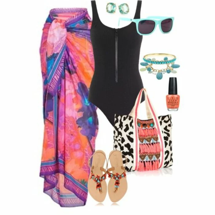 black swimsuit, near large floral sarong in orange pink and blue, sunglasses and earrings, bracelets and nail polish, large beach bag and sandals