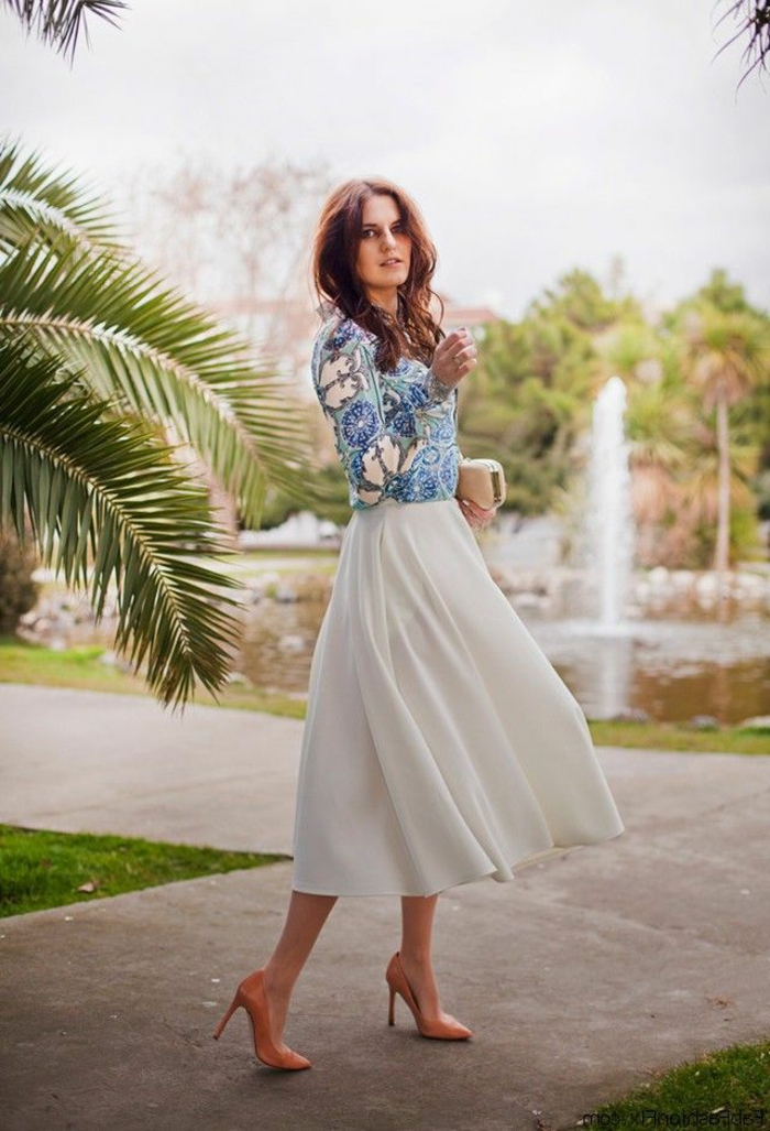 business casual attire for women, woman with wavy brown hair, wearing white floaty ankle-length skirt, nude pink stilettos and blue and white floral top