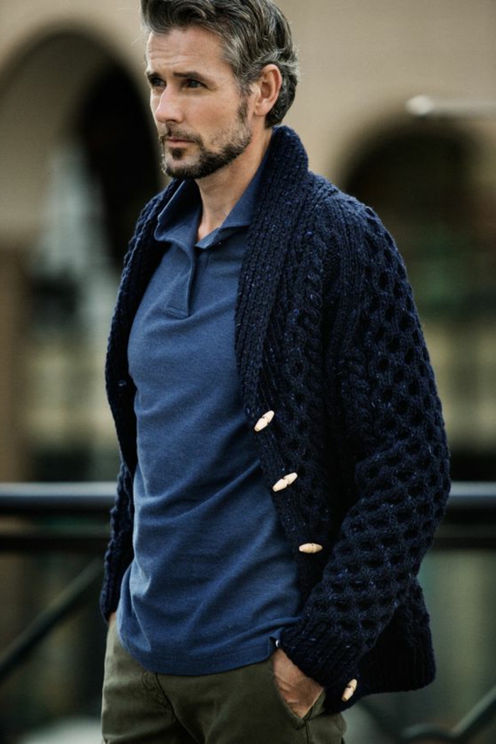 business casual outfits, older man with grayish hair, mustache and beard, wearing chunky-knit navy blue cardigan with white buttons, over blue shirt and khaki pants