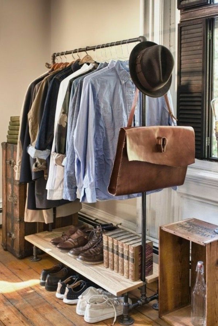business professional attire, metal clothes rack, pale blue shirts, various tops and blazers, several pairs of shoes, books a bag and a hat