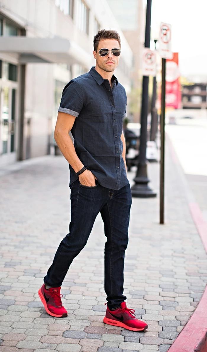 business casual outfits, man with sunglasses, wearing dark denim shirt with short sleeves, dark jeans and bright red sneakers