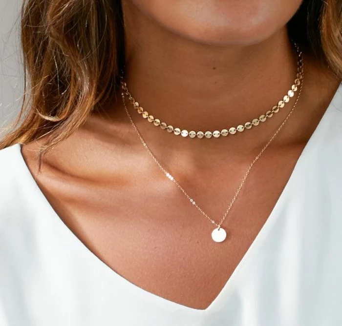 business casual for women, close up of woman's neck, wearing delicate chocker necklace and pendant on thin chain, white top and brown hair
