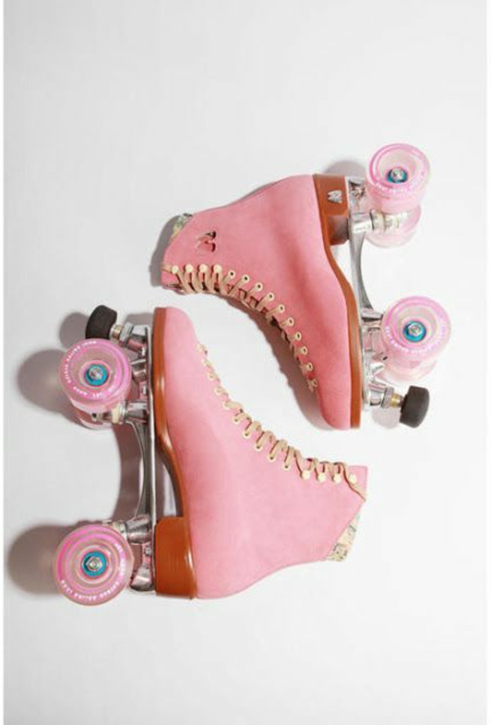 what did people wear in the 80s, pair of pink retro lace-up roller skates, pink wheels and peach colored laces, white background