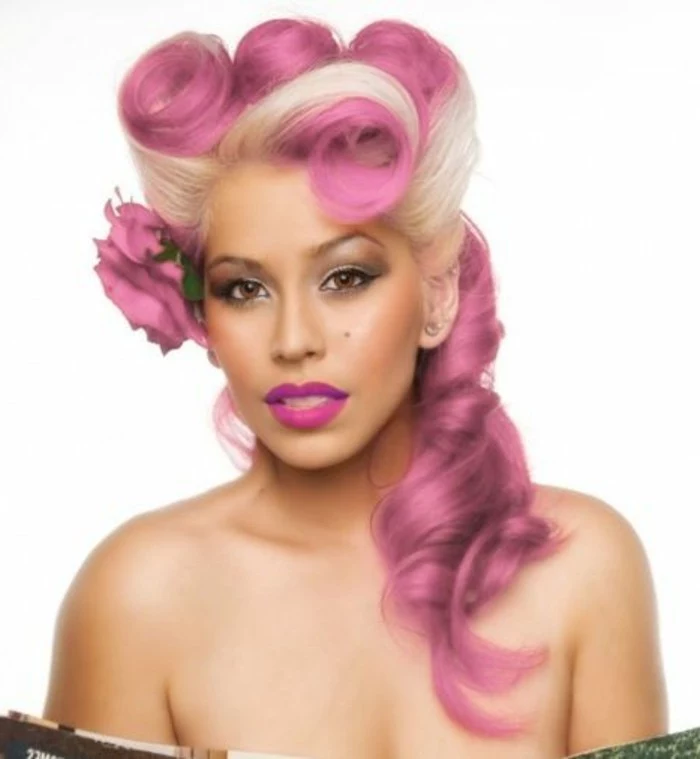 olive-skinned woman with brown eyes, platinum blonde and pink hair, victory rolls and curls, deep pink lipstick and heavy make up