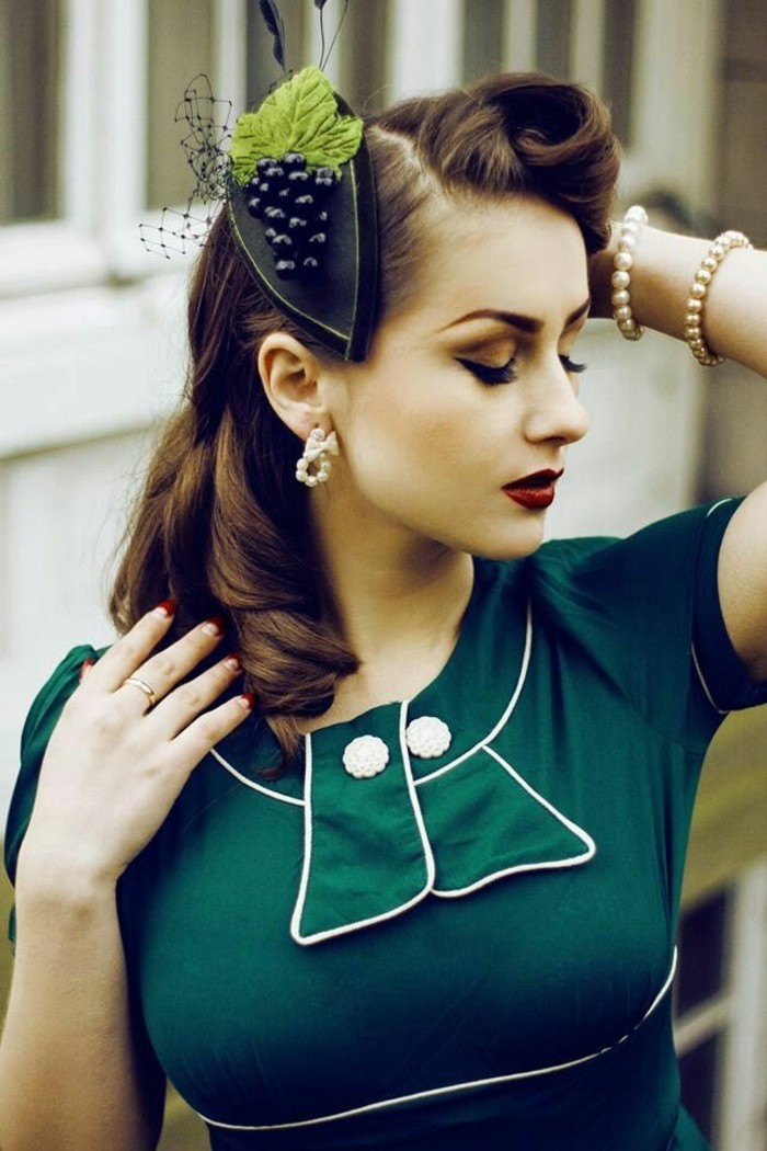 vintage hairstyles, brunette woman with retro 1950's hairstyle, curls and victory rolls, a hair ornament with grape bunch detail, dark green dress with white buttons