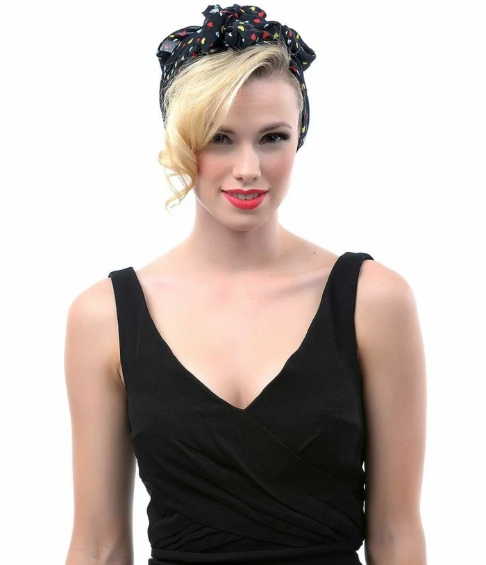 pin up girl hairstyles, girl with long blonde bangs curled at the end, wearing black bandanna with red and yellow heart print, black tank top, bright red lipstick and eye makeup