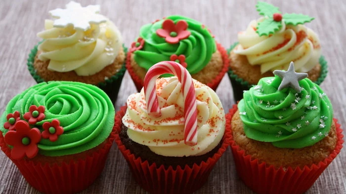 christmas cupcakes, six cupcakes with white or green frosting, decorated with christmas-themed fondant shapes