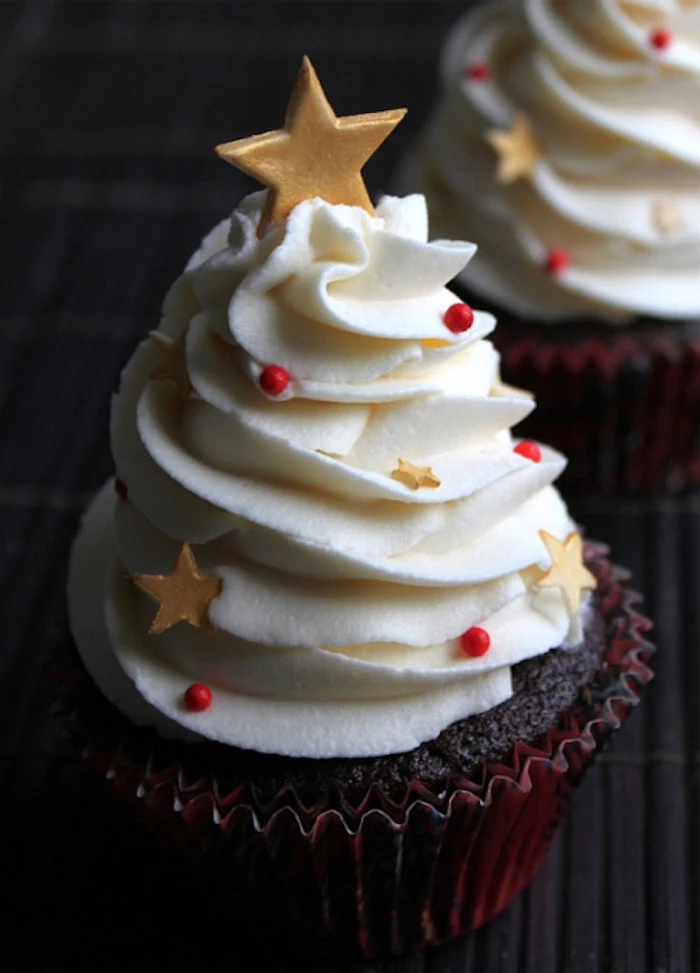 christmas cupcakes, chocolate cupcake with dark brown wrapper, creamy white frosting decorated with red pearls and yellow stars