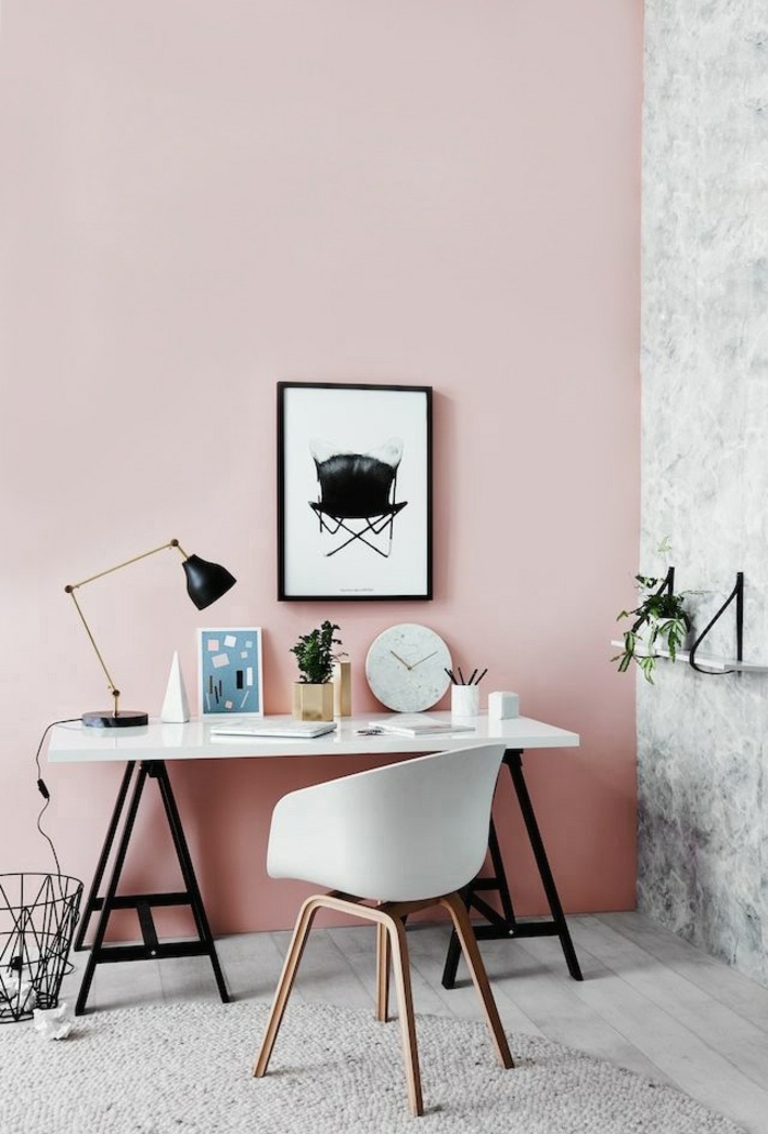 two tone living room walls, room with one pink and one grey wall, white desk with black legs, white chair with brown legs, black and white image in black frame, pale grey floor and rug