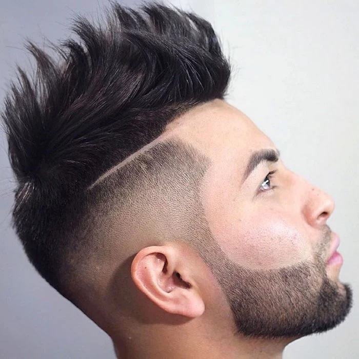 undercut hairstyle men, close up of asian man facing up and sideways, black beard mustache and side hair trimmed short, top hair kept long and gelled up