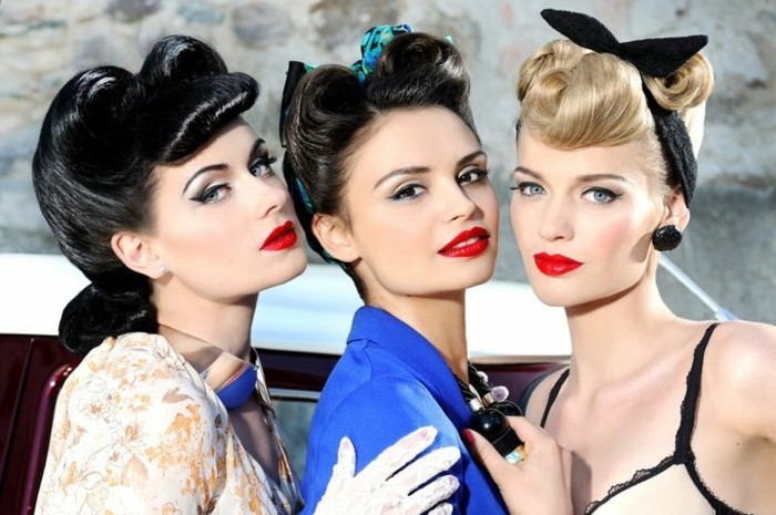 three woman with black, brunette and blonde hair, 1940's hairstyles victory rolls curls, black eyeliner mascara red lipstick, vintage clothes and accessories