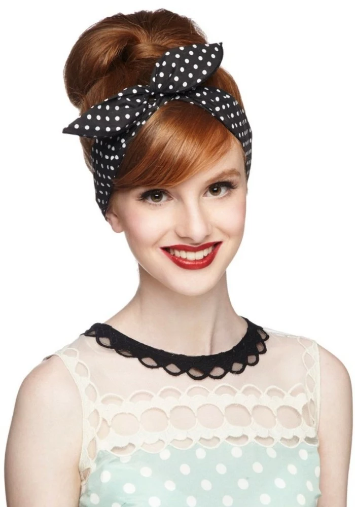 pin up girl hairstyles, smiling copper red-haired woman, with retro-styled hair in a bun and side bangs, wearing black bandanna and a retro dress, red lipstick big white teeth