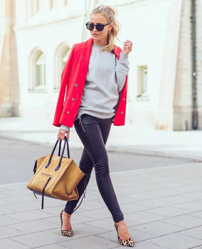 business casual attire for women, blonde woman with ponytail, wearing grey top and black leather trousers, hot pink blazer over shoulders, with high heels and camel brown leather bag