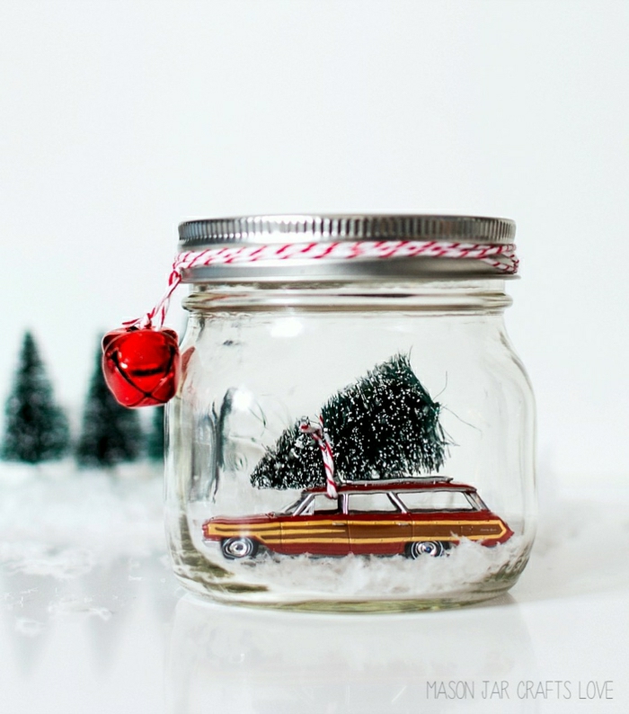 homemade christmas gift ideas, reddish -brown retro car miniature, inside a clear bell jar with screw cap, small tree figurine tied to car with red and white string, red bells tied to jar lid