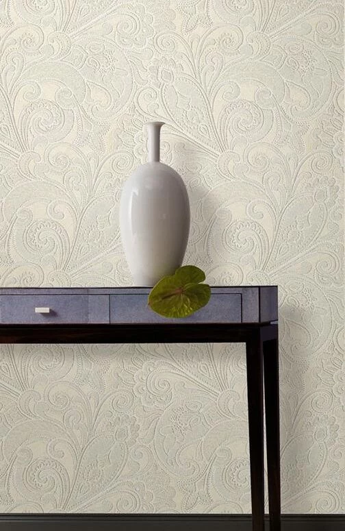 rococo-style wallpaper in cream, abstract floral pattern, minimalist brown wooden table and white vase