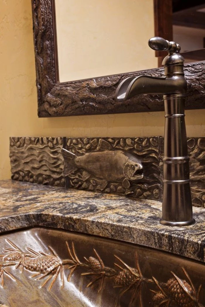 bathroom design ideas, close up of ornate metal sink with fish detail and marble top, vintage looking tap, mirror with old metal frame