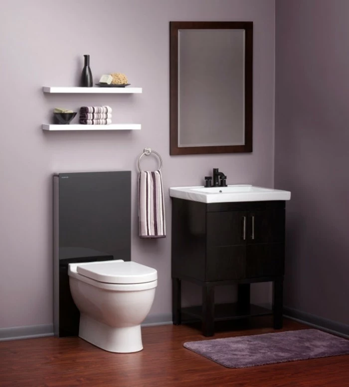 bathroom ideas photo gallery, pale purple walls, dark wooden floor, fluffy purple rug, black and white toilet, black cupboard with white sink