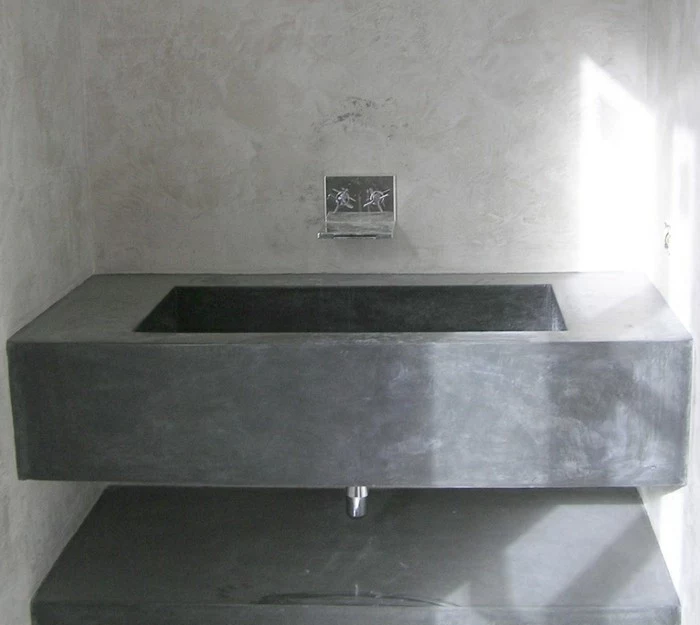 bathroom makeovers, massive grey concrete sink, metal taps on light grey-wash wall