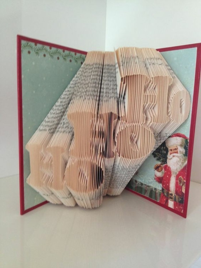 book folding patterns, book with red and pale green covers, decorated with santa claus image, and other festive details, opened to reveal the words ho ho ho, made from folded pages