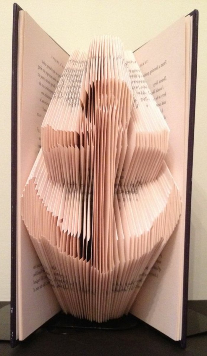 anchor shape created from folded pages, inside an open book, with hard black covers
