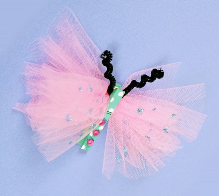 diy projects for kids, butterfly made from pale pink tulle, with silver sparkling details, multicolored clothes peg and fuzzy wire