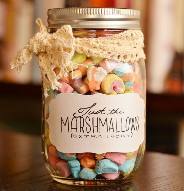 mason jar filled with small multicolored marshmallows, with silver lid and white hand-written label, tied with a cream lace bow