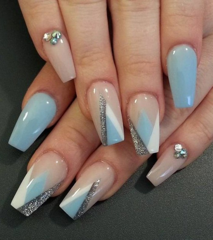 pastel blue and pastel pink nails, decorated with rhinestones, white and silver details