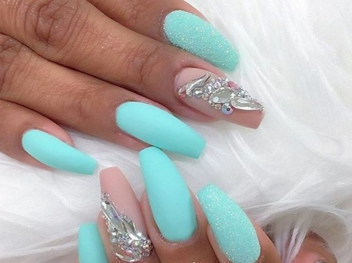 tan hands with long sharp and semi-square nails, turquoise and pink nail po...