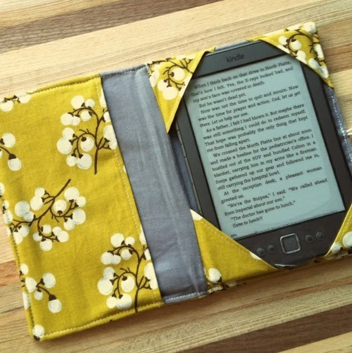 best friend christmas gifts, black kindle inside a handmade cover, made from floral yellow and plain grey fabric