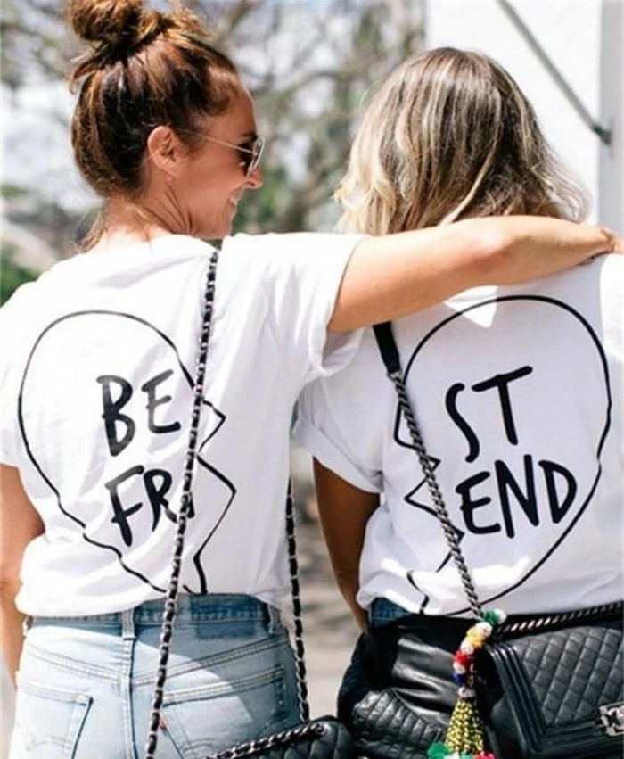 cool gifts for teens, two girls with backs facing the camera, wearing matching best friend t-shirts in black and white, one girl hugging the other