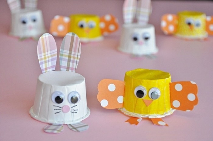 easy kids crafts, bunny and chick decorations, made from small paper cups in white and yellow, decorated with colorful paper and stick-on eyes
