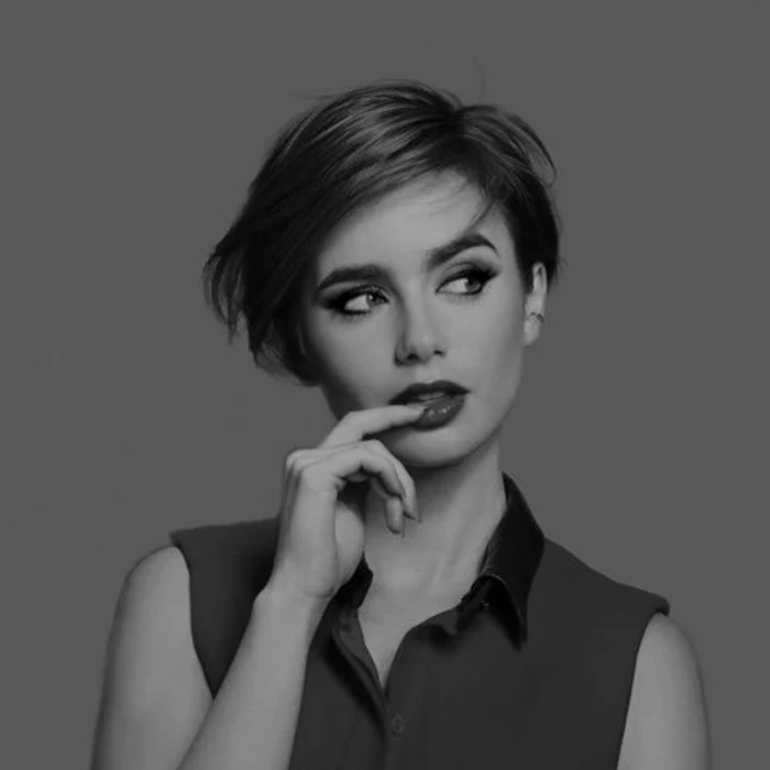 pixie cut, black and white image of lily collins, short dark hair with side parted bangs, wearing sleeveless shirt