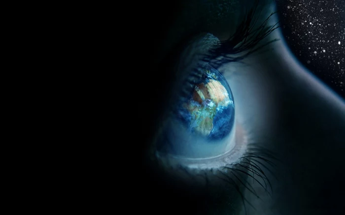 different colored eyes, close up to blue human eye, the planet earth is reflected inside, shadows and a black background with stars
