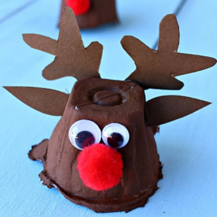 diys for your room, little reindeer ornament, made from brown cardboard cup, decorated with stick-on eyes, paper ears and antlers, and a red pom pom nose
