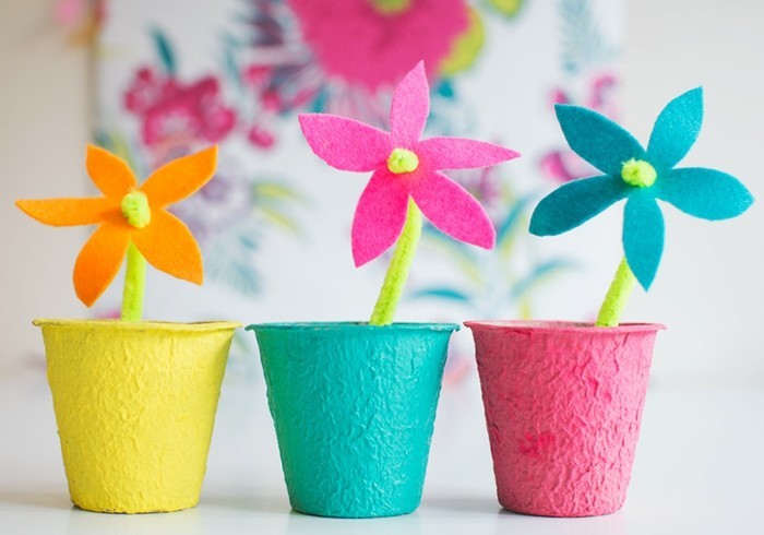 diy art projects, three felt flowers in orange, pink and turquoise blue, placed in bright and colorful pots