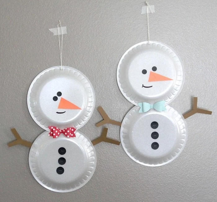 diys for your room, two snowmen made from two paper plates stuck together, decorated with paper cutouts, black buttons and colorful bowties