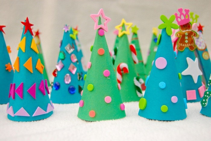 diys for your room, many christmas trees, made from green and blue felt, decorated with different cutouts, shapes and sticky shiny gems