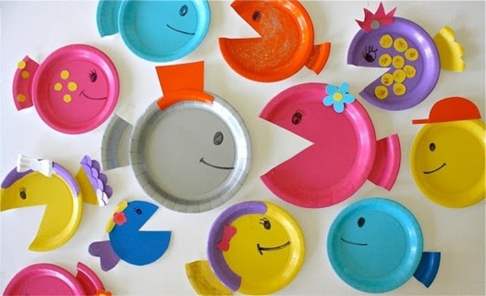 fun art projects, several paper plates in different colors, made to look like fish, decorated with colorful paper cutouts