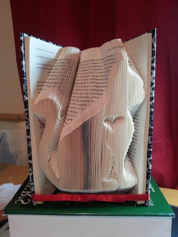 folded book patterns, book with hard black and white patterned covers, opened to reveal a cat shape, with little heart inside, made from many folded pages