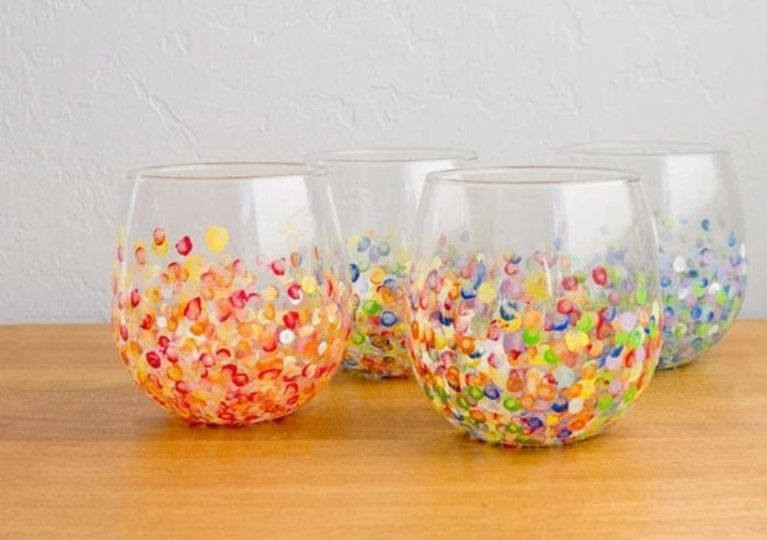 hand painted clear glasses, a set of four, with red and yellow, blue white and violet, and multicolored spots